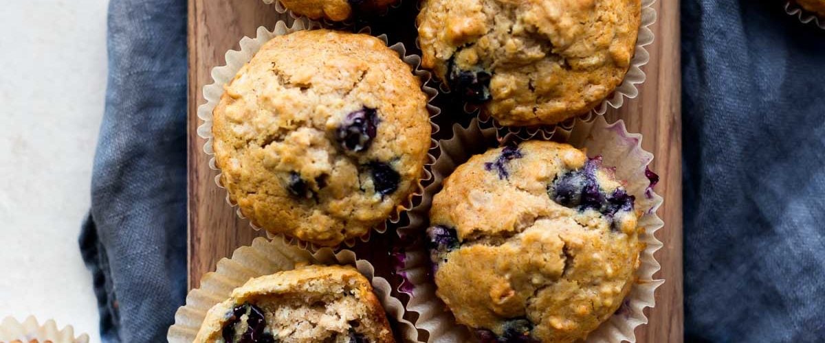 Blueberry oatmeal muffins on wood board