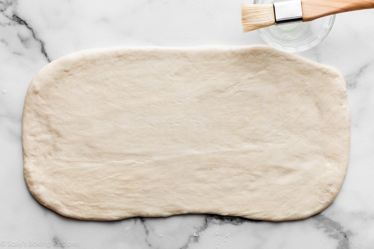 rolled out dough on marble counter.