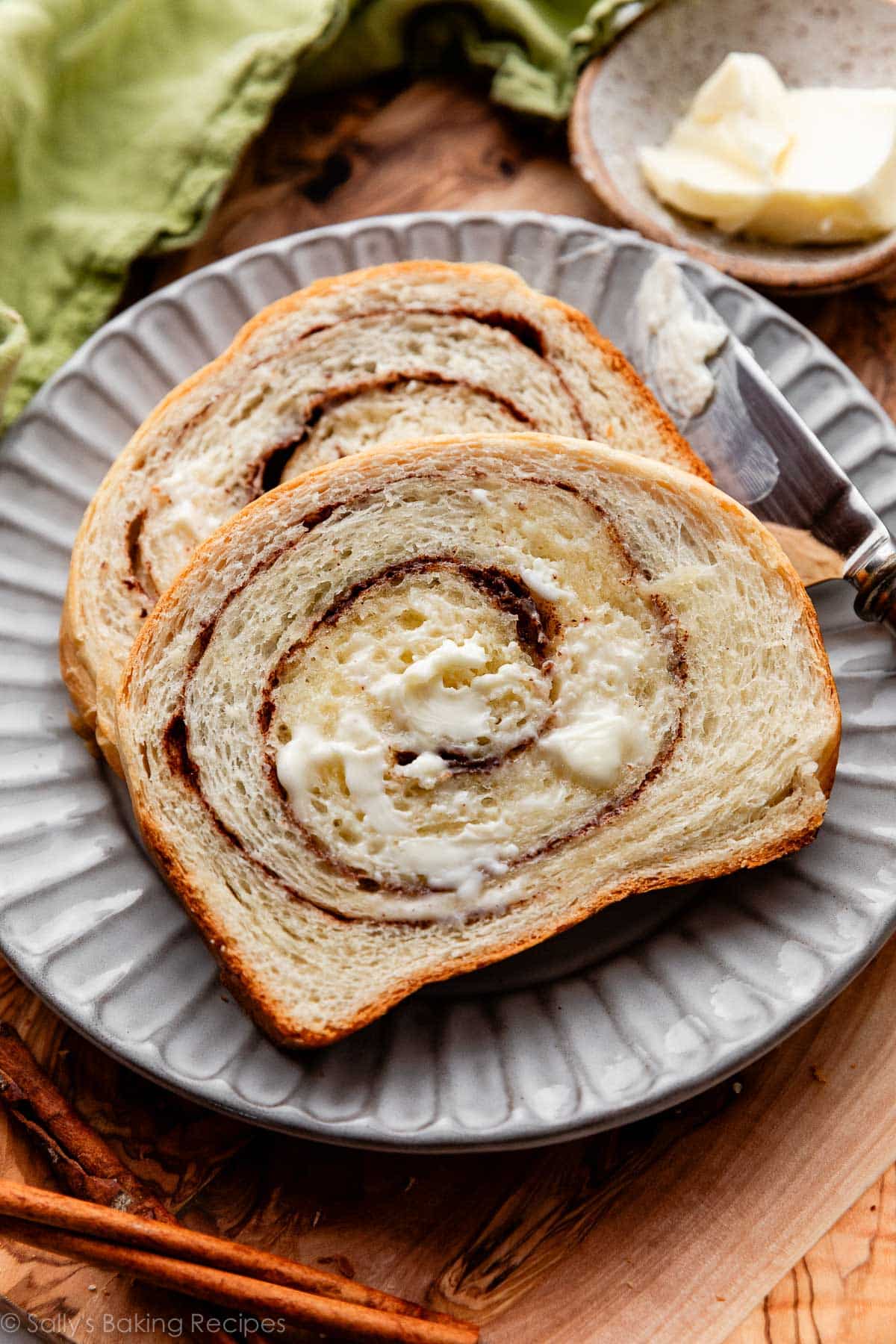buttered slices of homemade cinnamon swirl bread on gray plate.