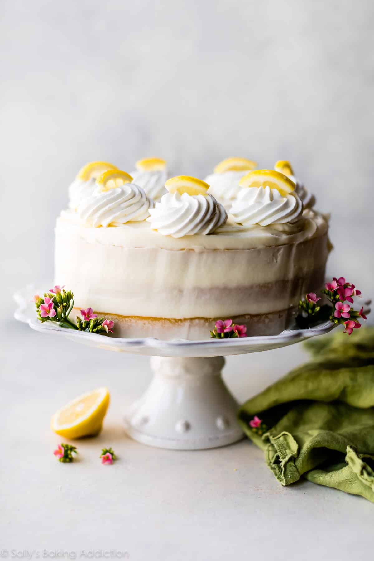 whole lemon cake on a white cake stand
