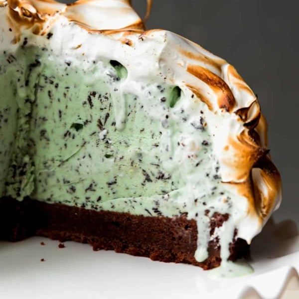 brownie baked Alaska on a white cake stand
