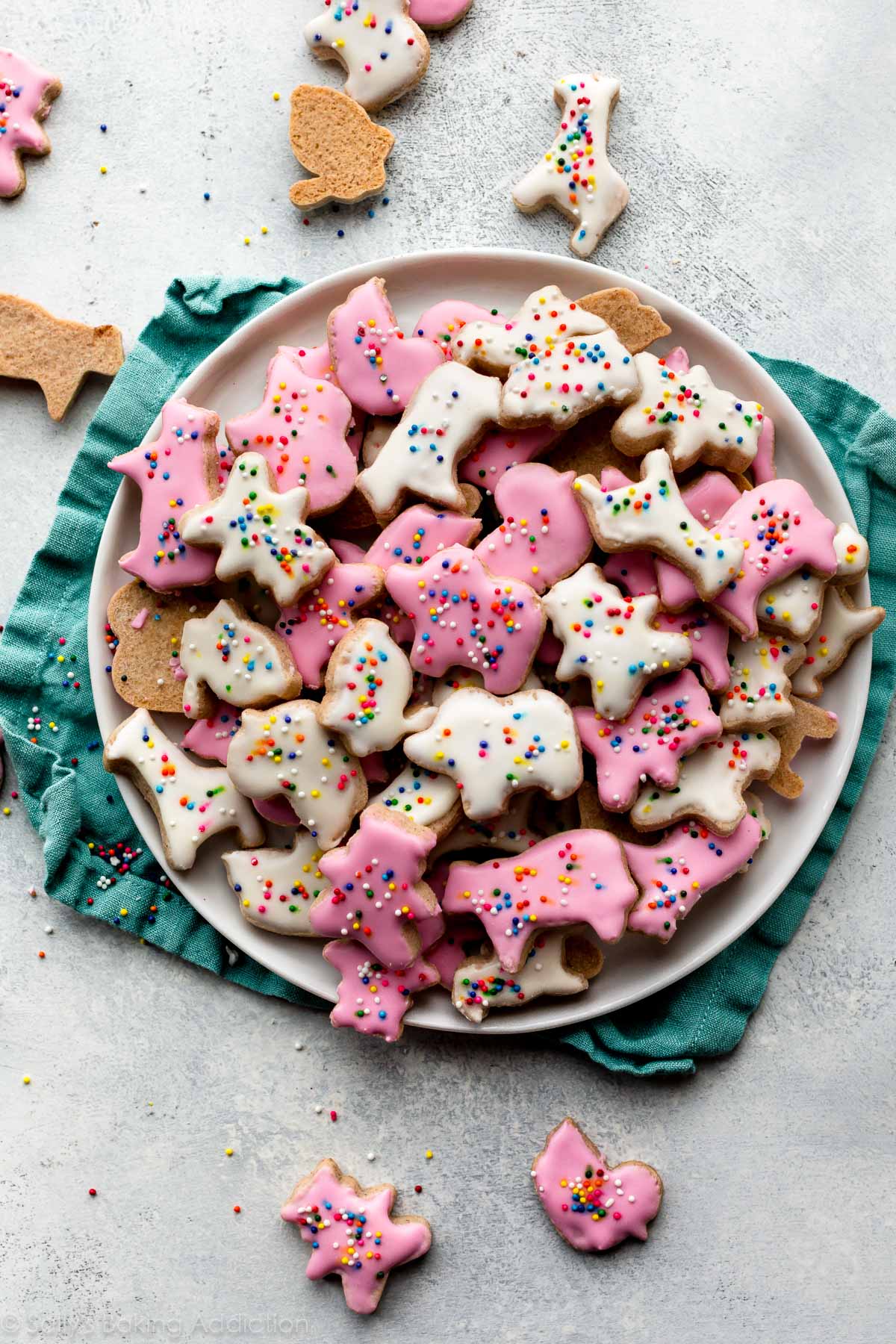 plate of animal cracker cookies with pink and white icing
