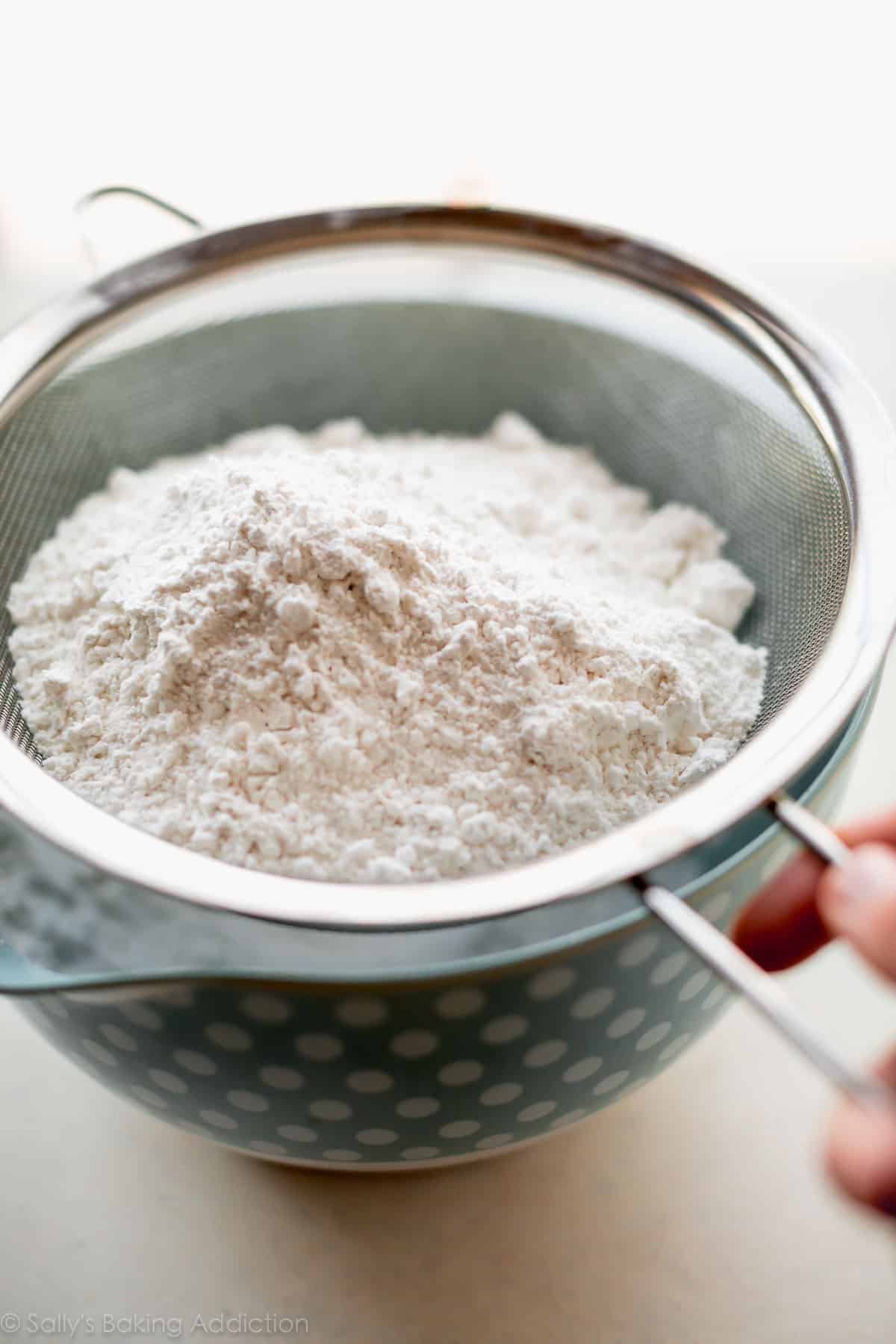 sifting flour with a mesh metal sieve