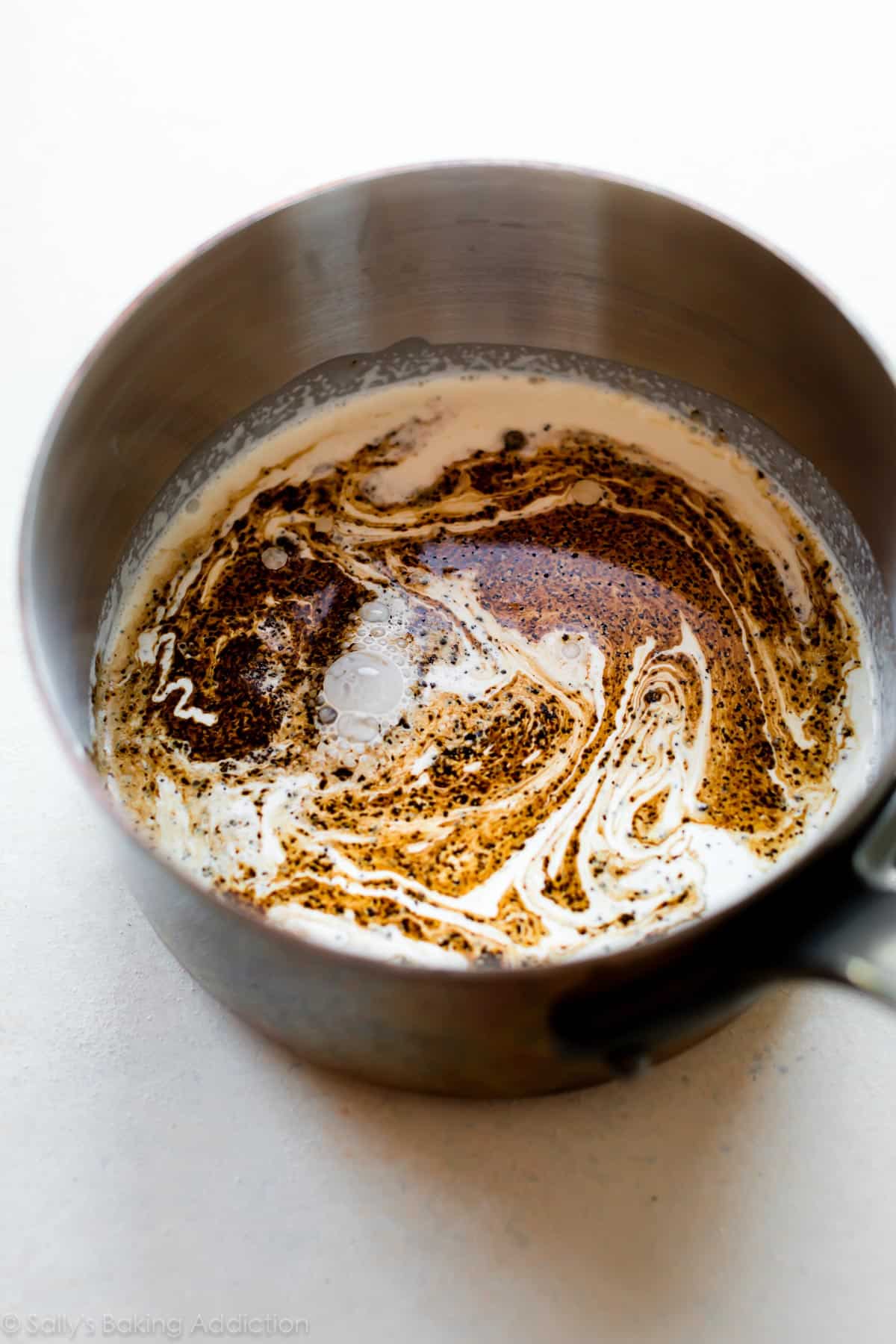 Heavy cream and espresso powder in a saucepan