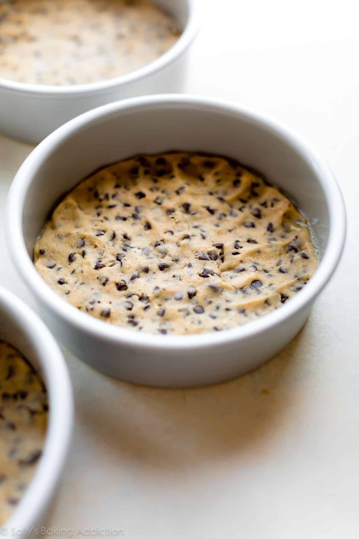cookie dough pressed into cake pans before baking