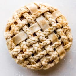 overhead image of a braided and latticed pie crust before baking