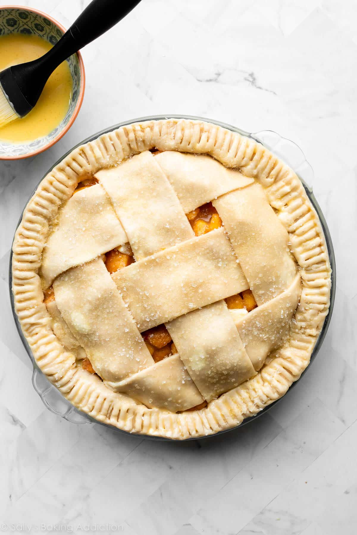 lattice-topped pie with crimped edges and brushed with egg wash.