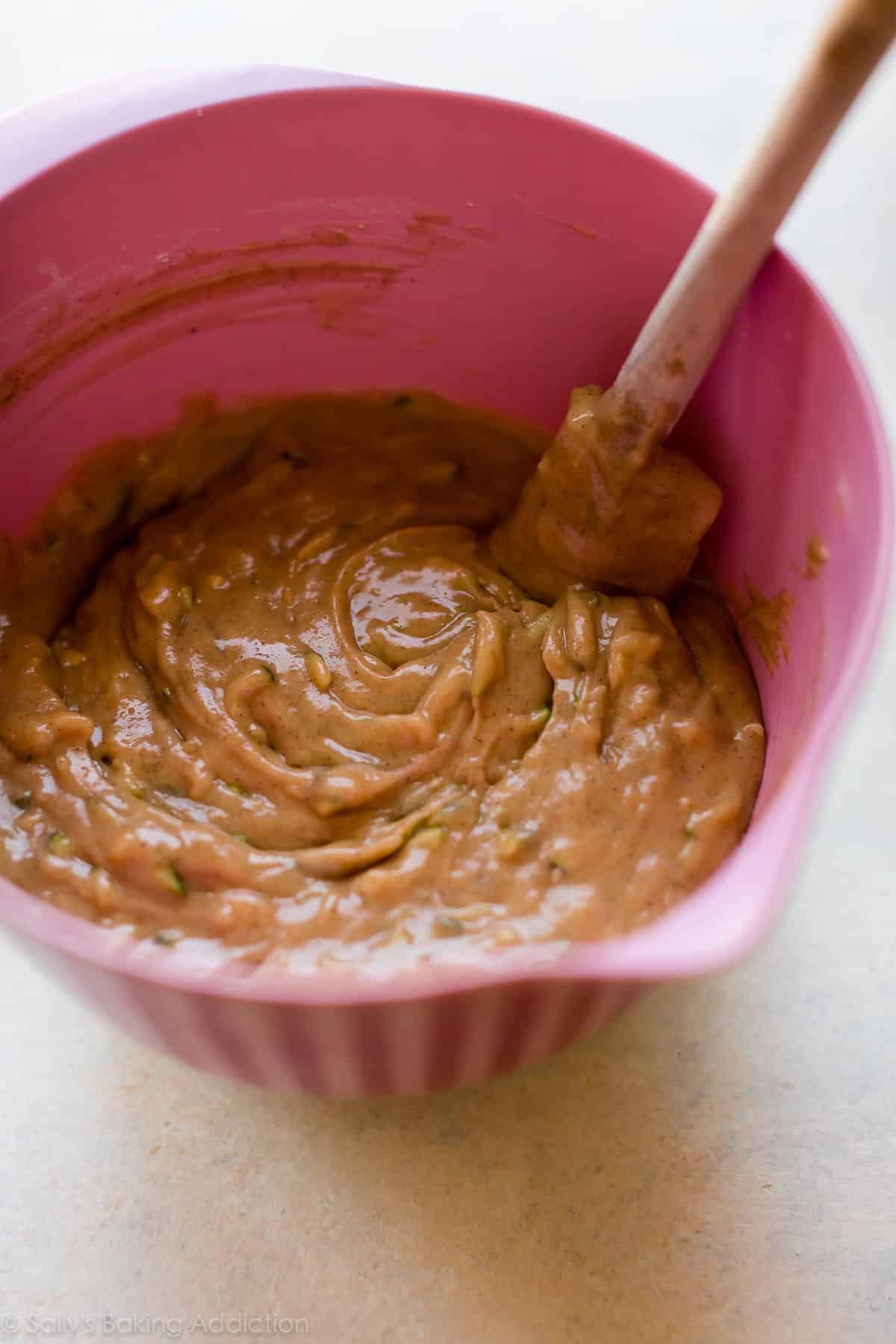 Zucchini crumb cake batter in pink mixing bowl