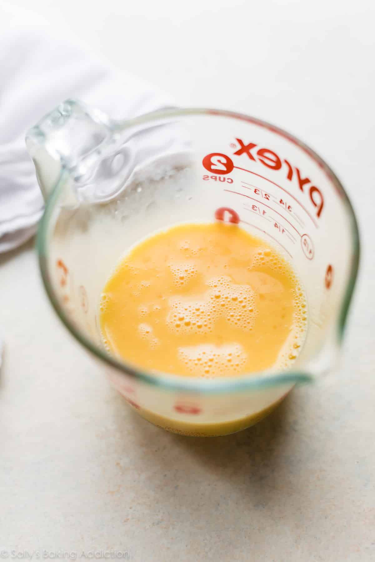 Beaten eggs in a glass measuring cup