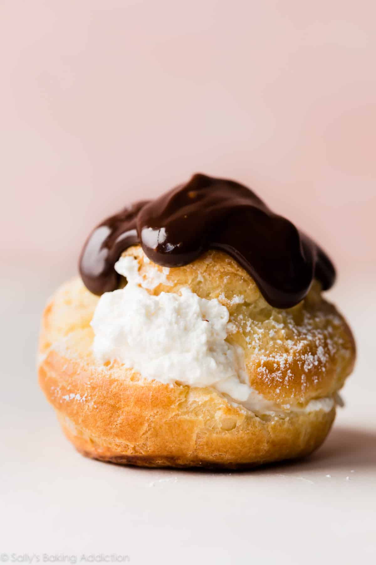 one cream puff topped with chocolate ganache