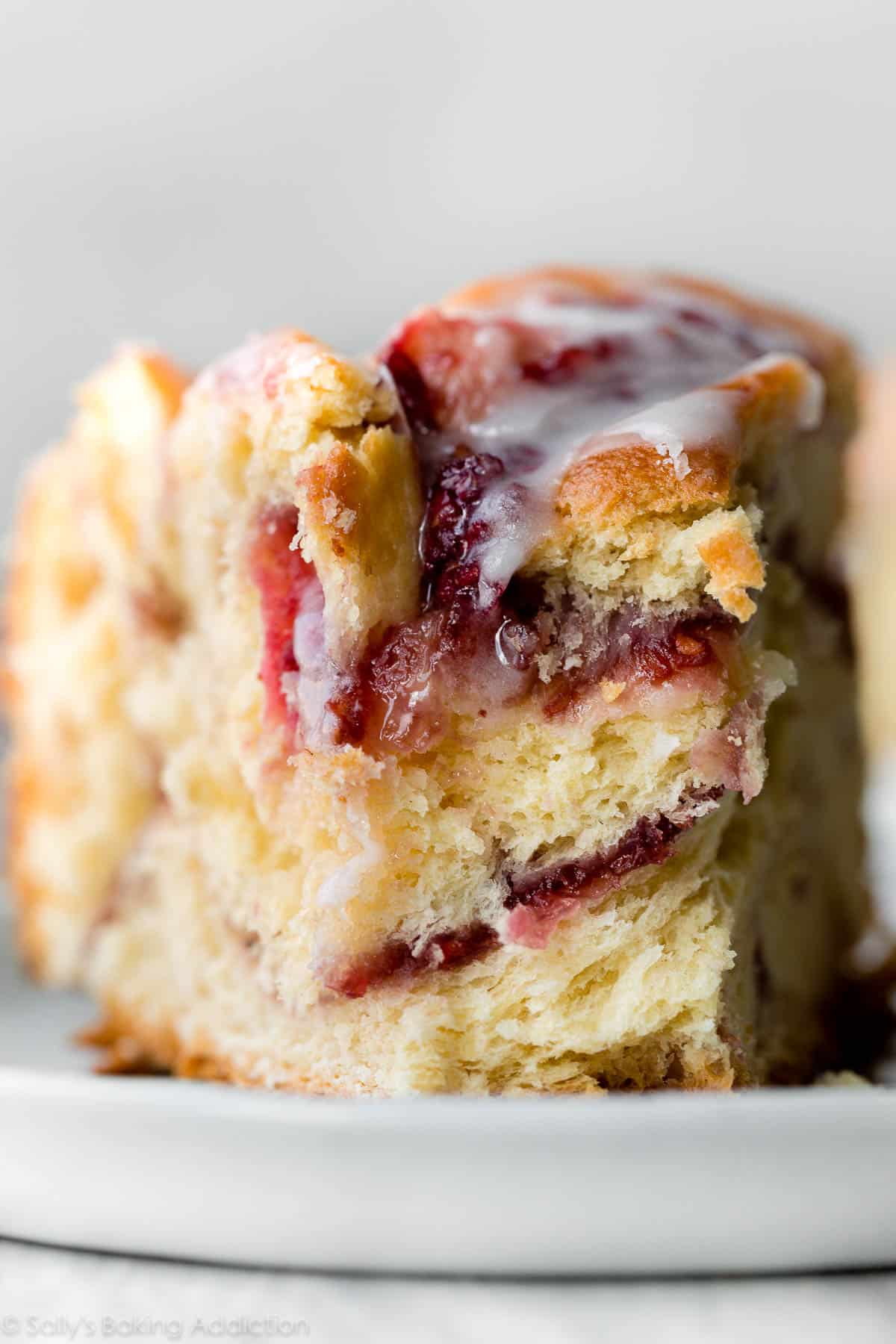 close up image of raspberry danish twist on a white plate