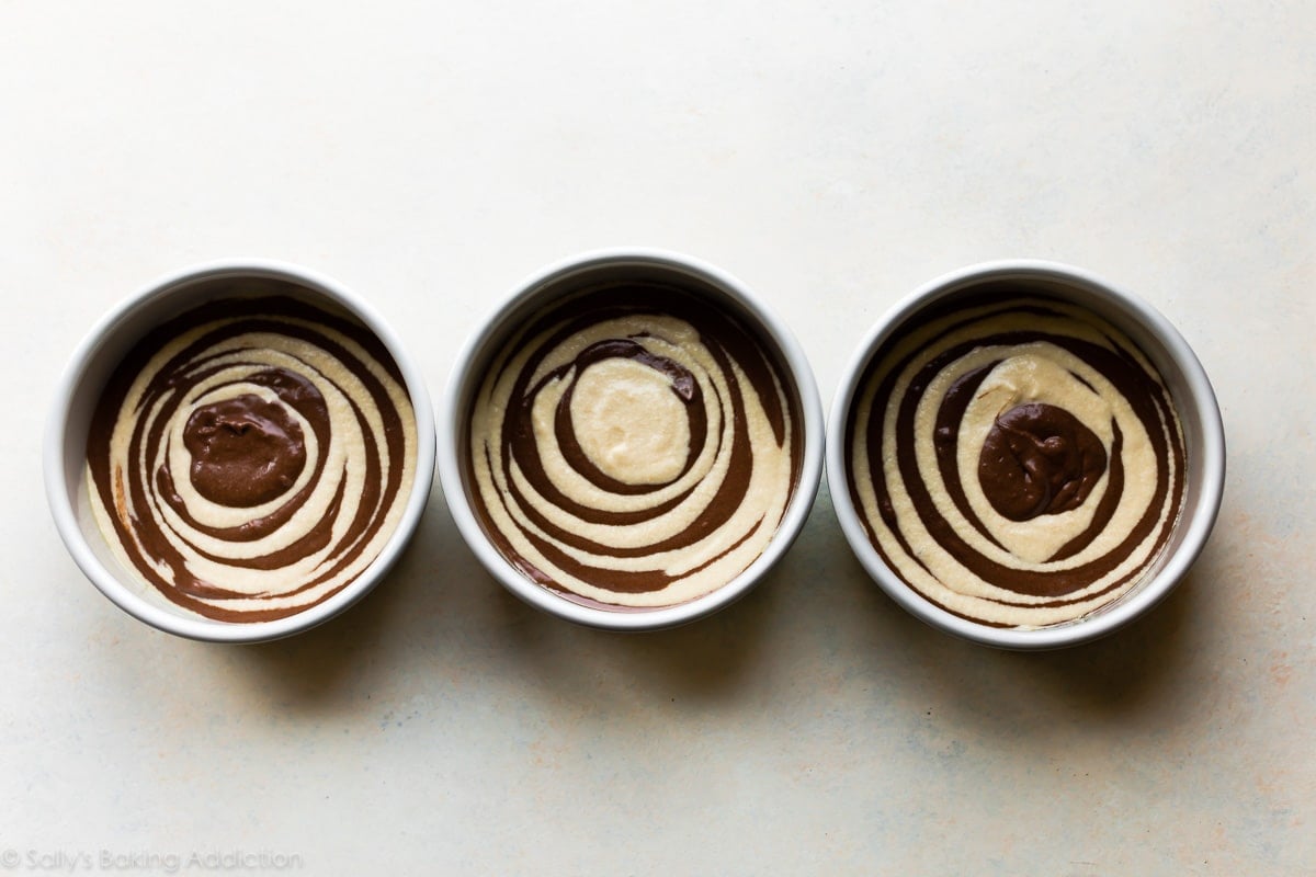 cake pans with marble cake batter before baking