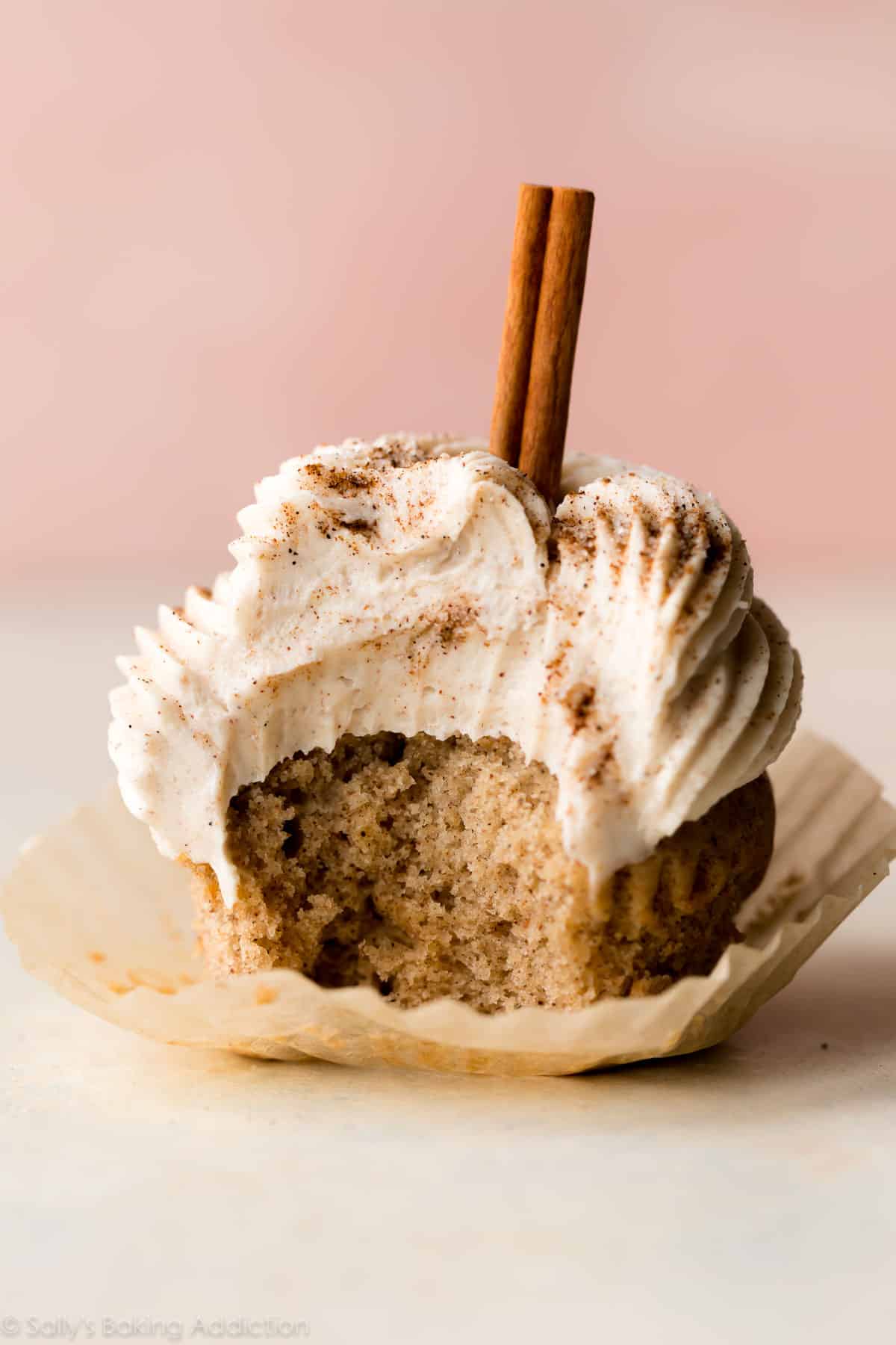 chai latte cupcake with a bite taken from it