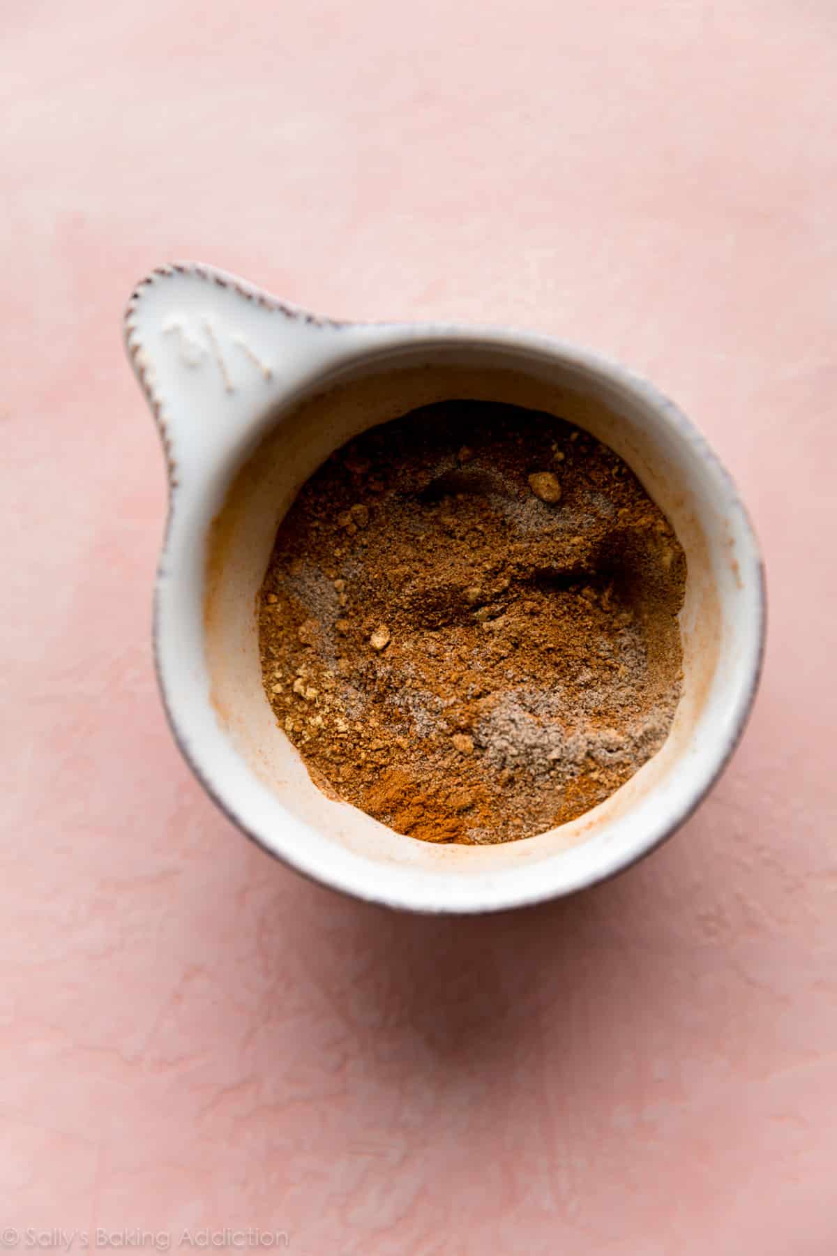 chai spice mix in a white measuring cup