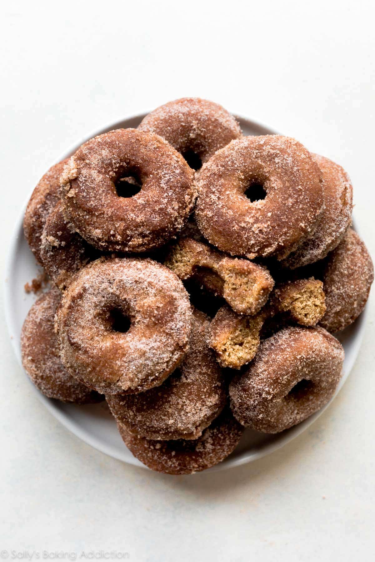 Baked apple cider donuts on a white plate
