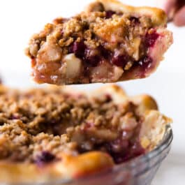 slice of cranberry pear crumble pie on a pie server