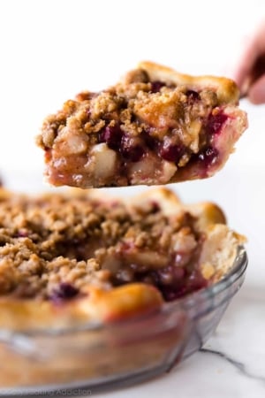 slice of cranberry pear crumble pie on a pie server
