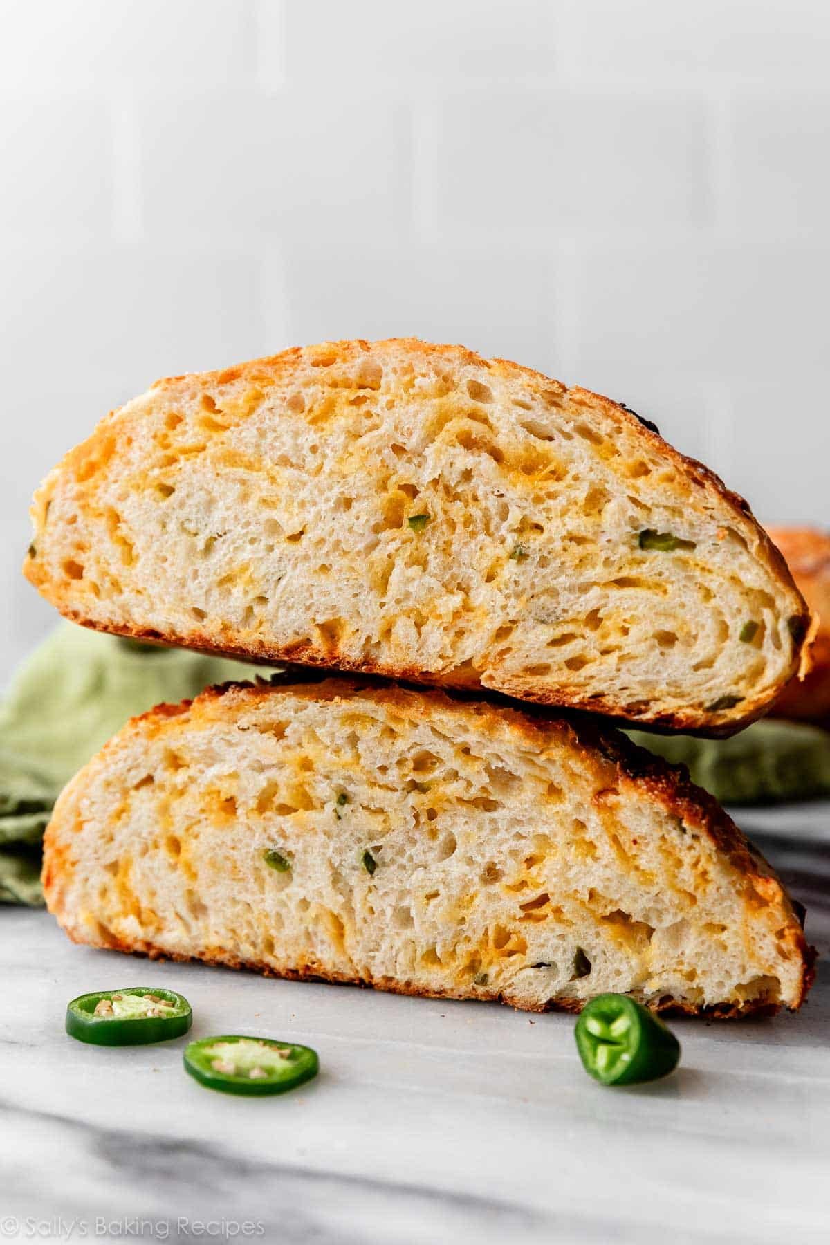 jalapeño cheddar bread boule cut in half and stacked on top of each other.