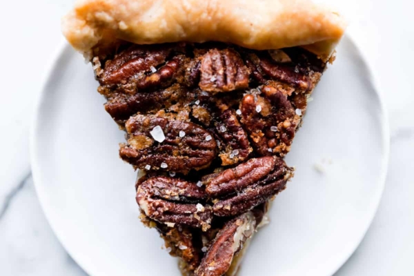 slice of maple pecan pie on a white plate