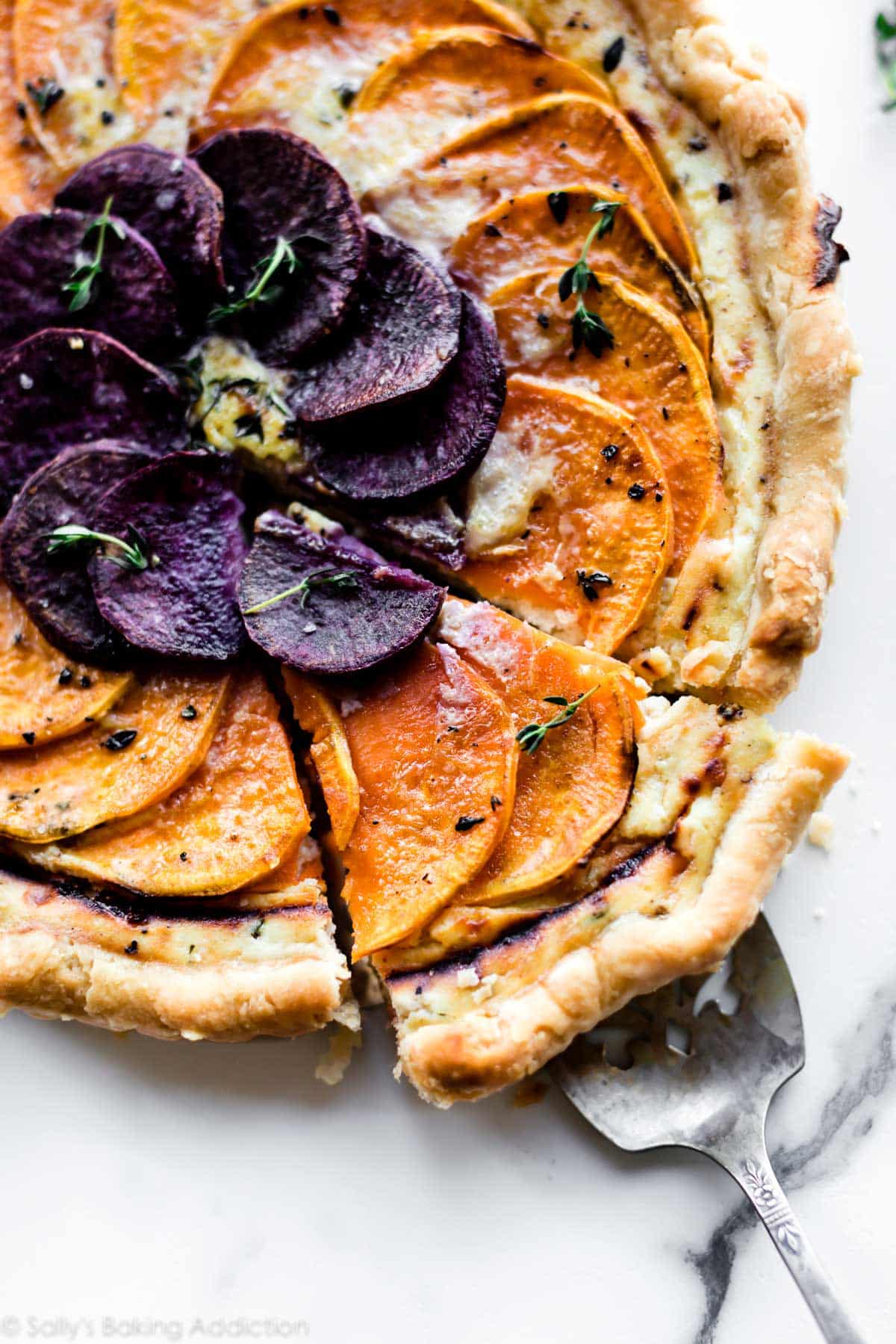 savory vegetable cheese tart with a slice on a serving utensil