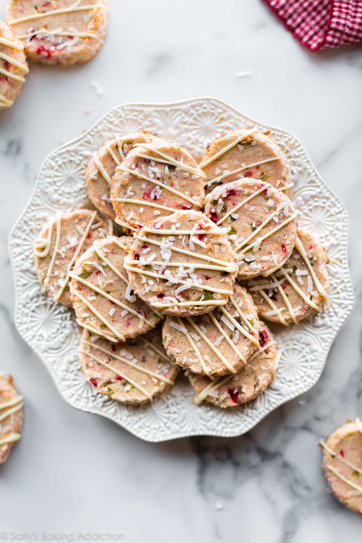 Santa's Whiskers Cookies with cherries, almond, coconut, and white chocolate on a white plate