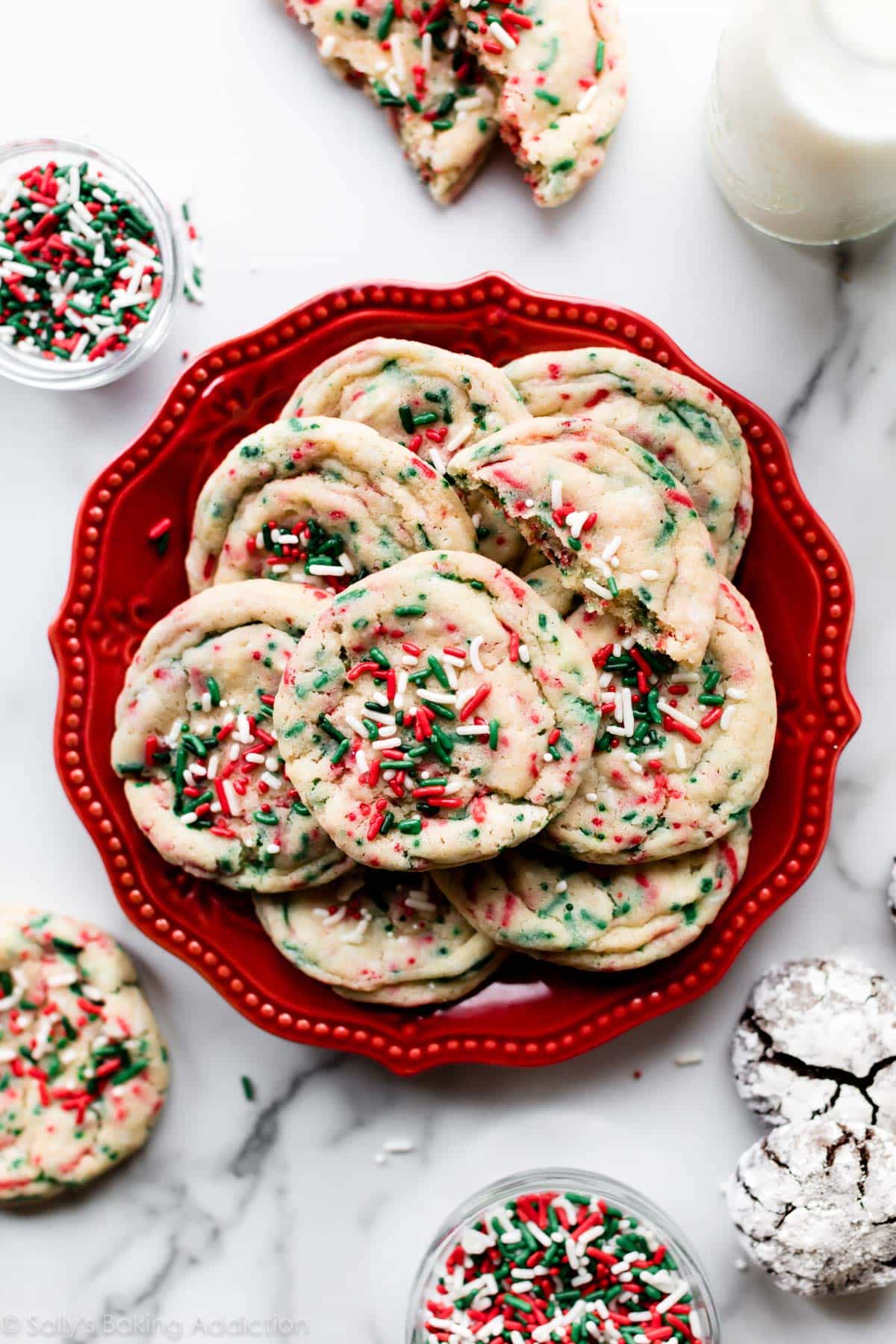 Christmas sprinkle sugar cookies on a red plate