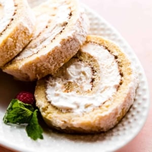 Champagne cake roll slices on a white serving platter