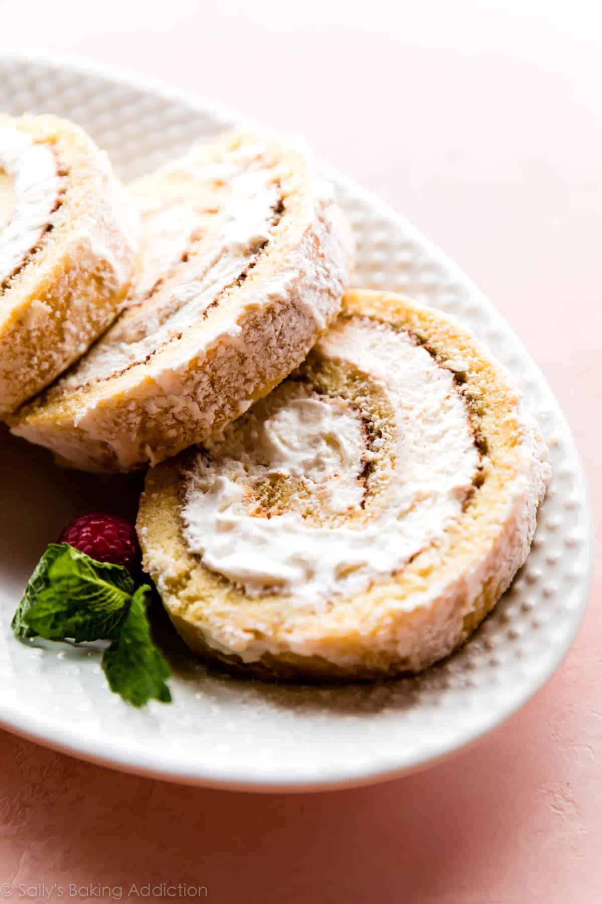 Champagne cake roll slices on a white serving platter