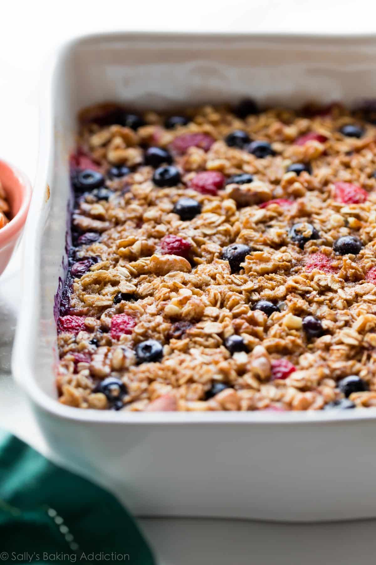 berry baked oatmeal in a white casserole baking dish