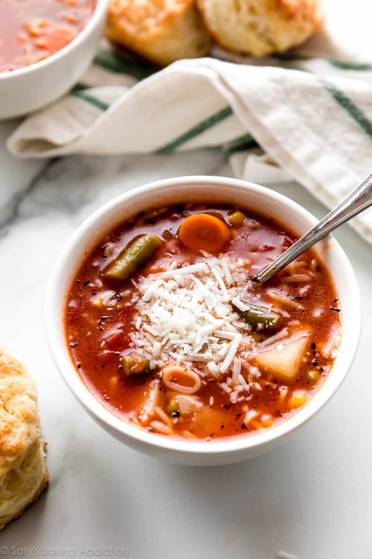 bowl of alphabet vegetable soup with parmesan cheese on top