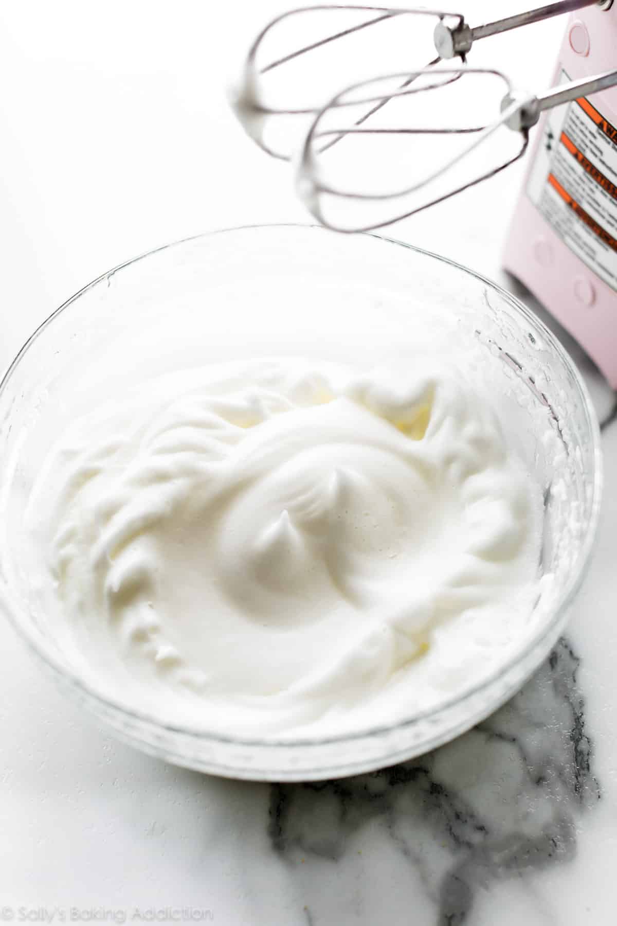 Whipped egg whites in a glass bowl