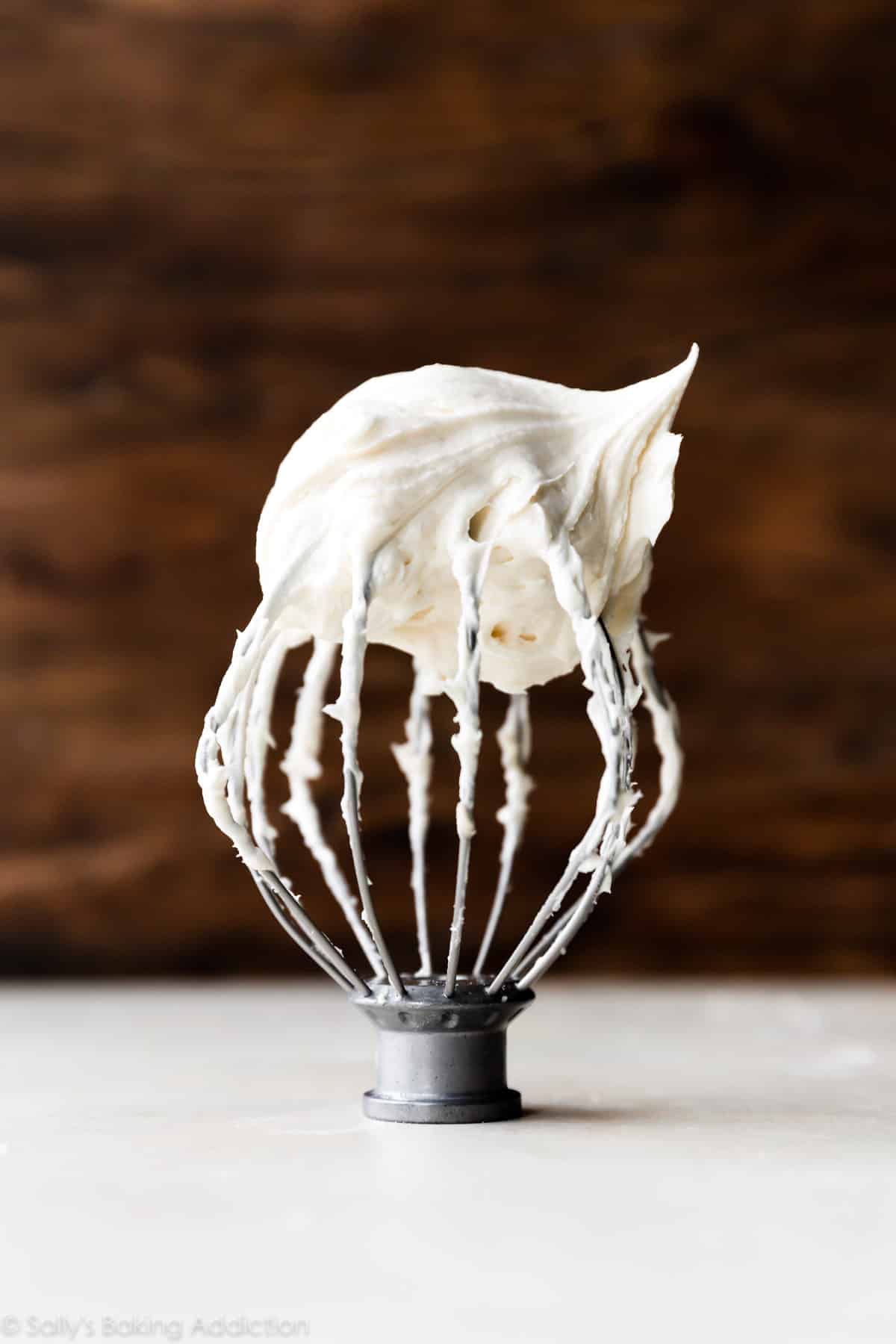 Cream cheese buttercream frosting on whisk