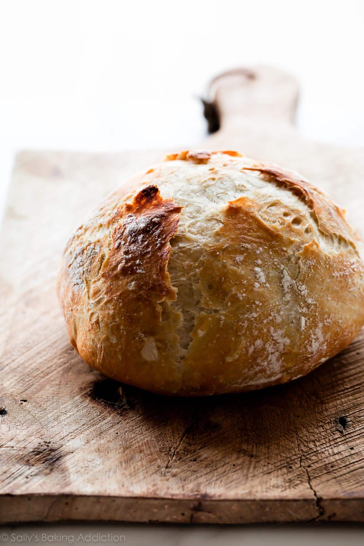 Loaf of no knead bread on wood board