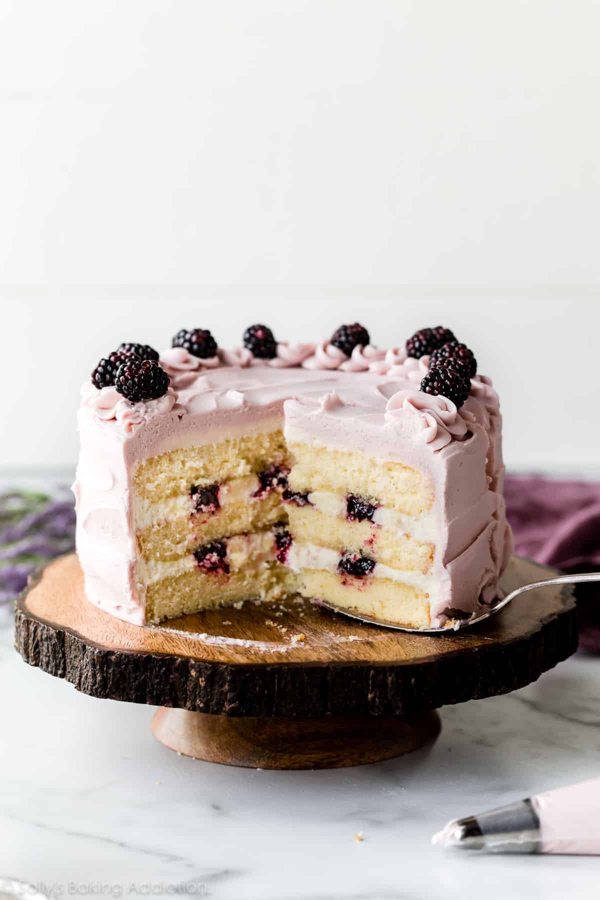 Blackberry lavender cake on wooden cake stand