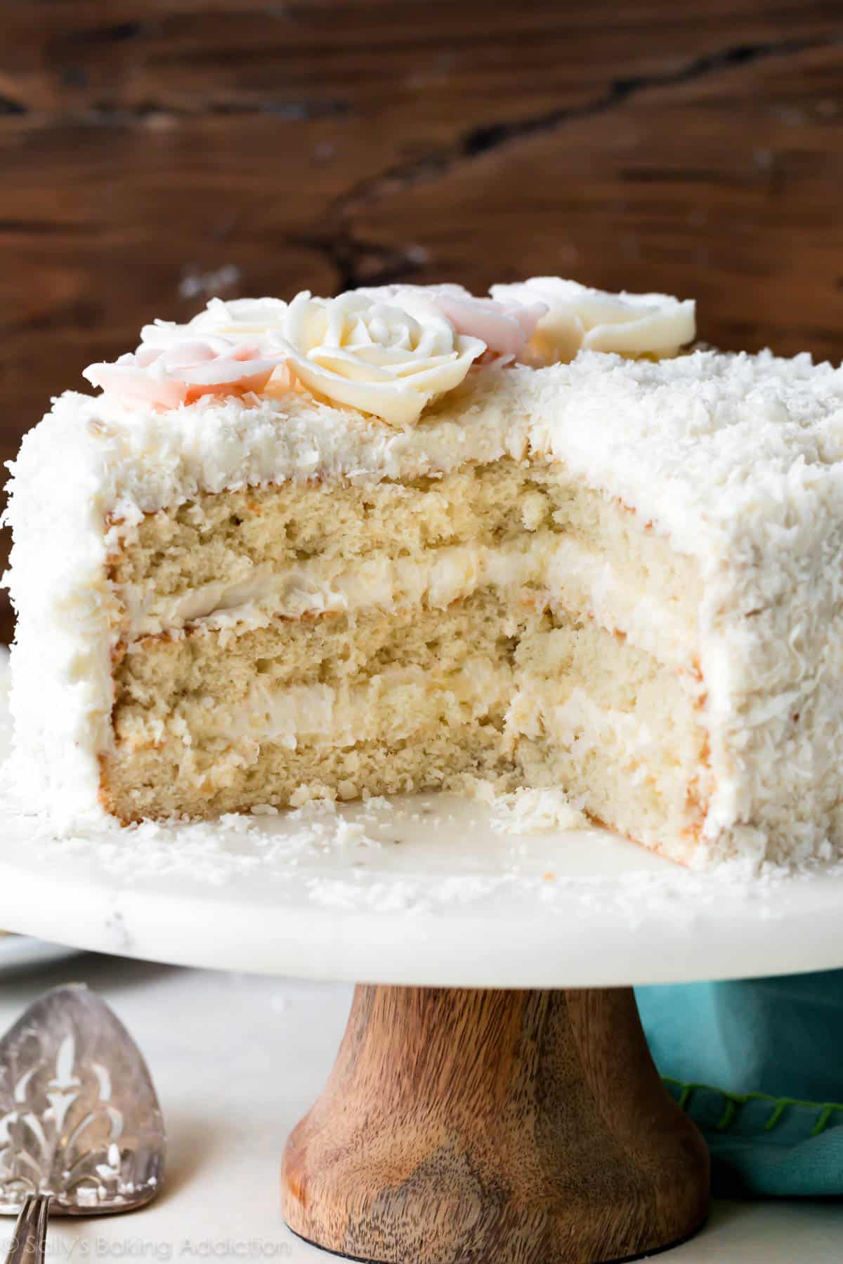 Coconut cake on a wood and marble cake stand