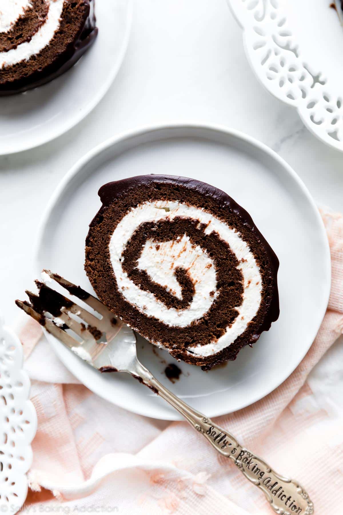 slice of chocolate Swiss cake roll on white plate