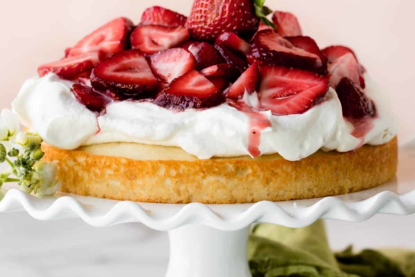 Strawberry shortcake cake on white cake stand