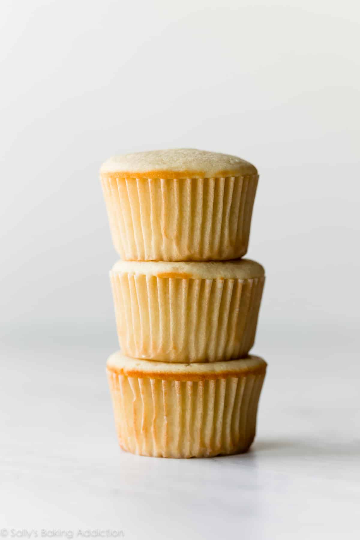 3 yellow cupcakes in a stack