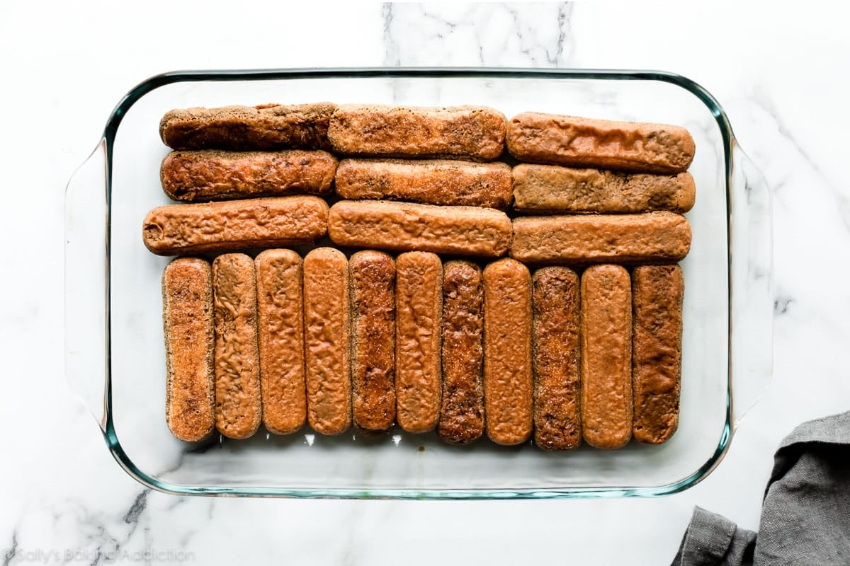 layer of espresso soaked ladyfingers in glass baking dish
