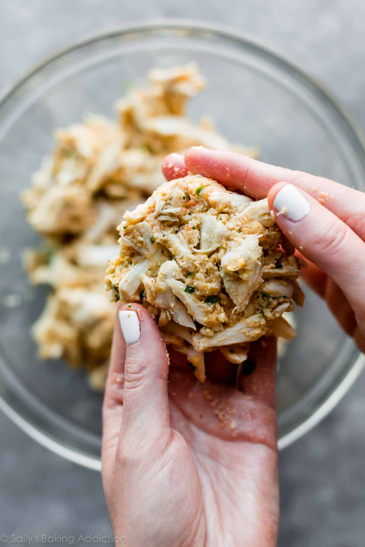 hands shaping crab cakes