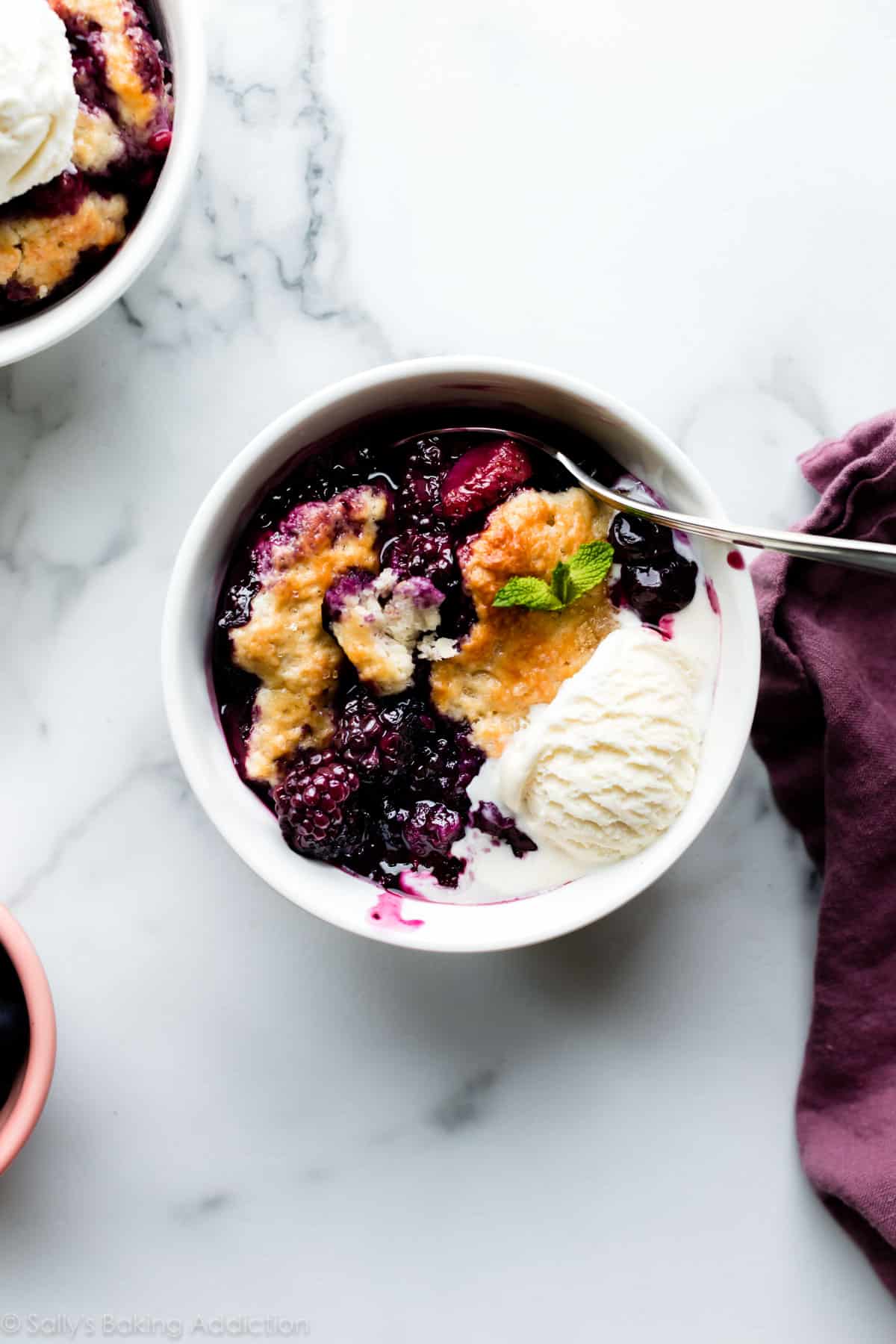 mixed berry cobbler serving with vanilla ice cream