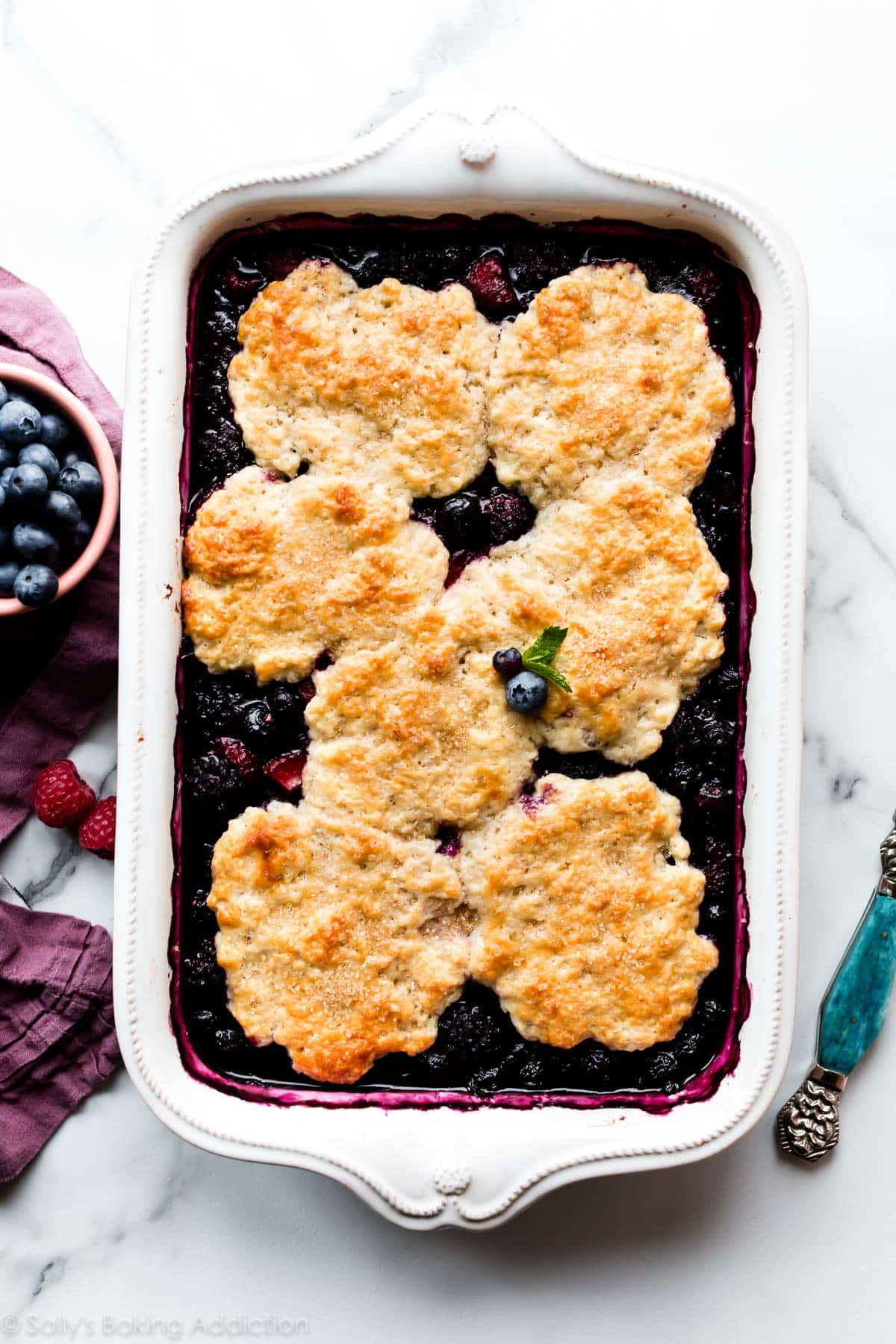 mixed berry cobbler in 9x13 inch white baking dish