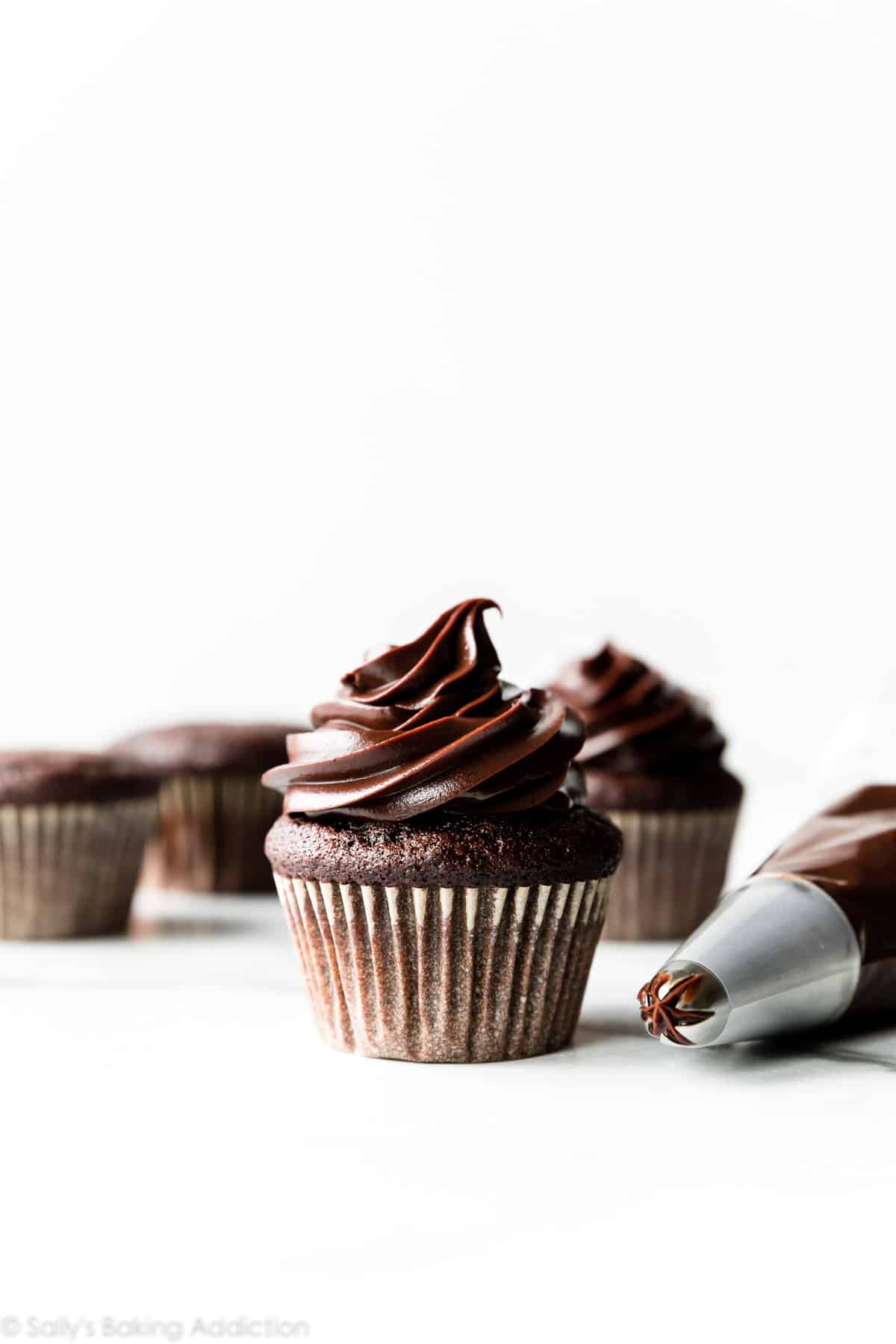 chocolate cupcakes with piped chocolate ganache