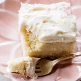 slice of vanilla sheet cake on a pink plate