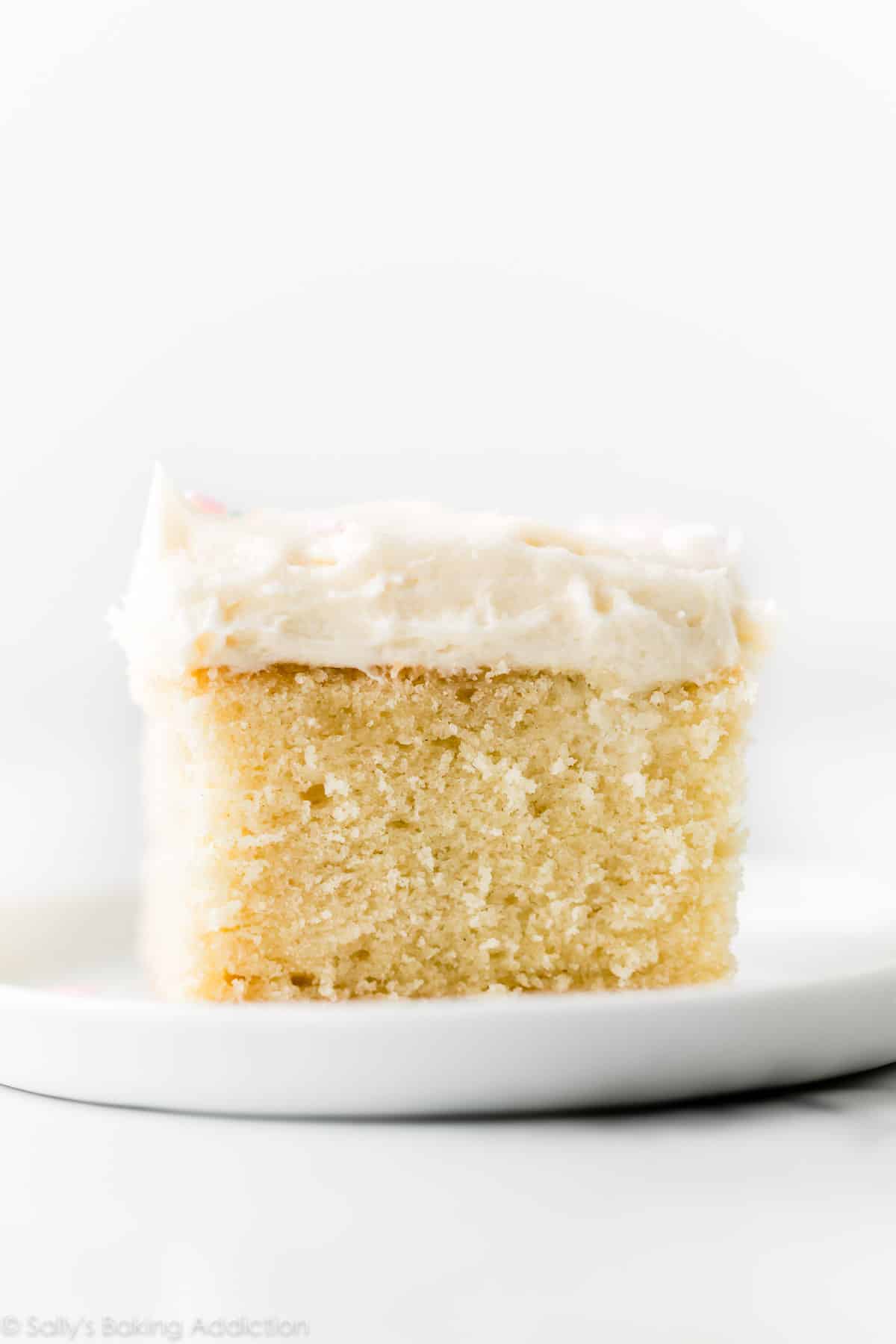 vanilla sheet cake slice on a white plate