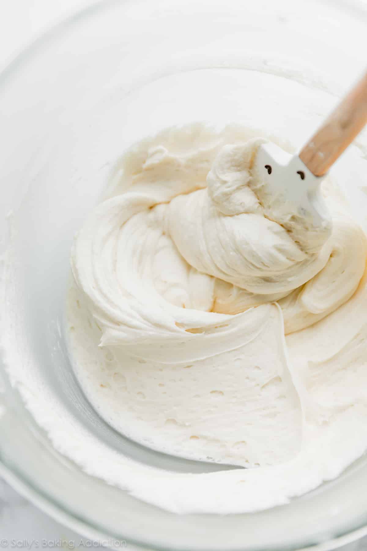 Whipped vanilla buttercream in a glass bowl