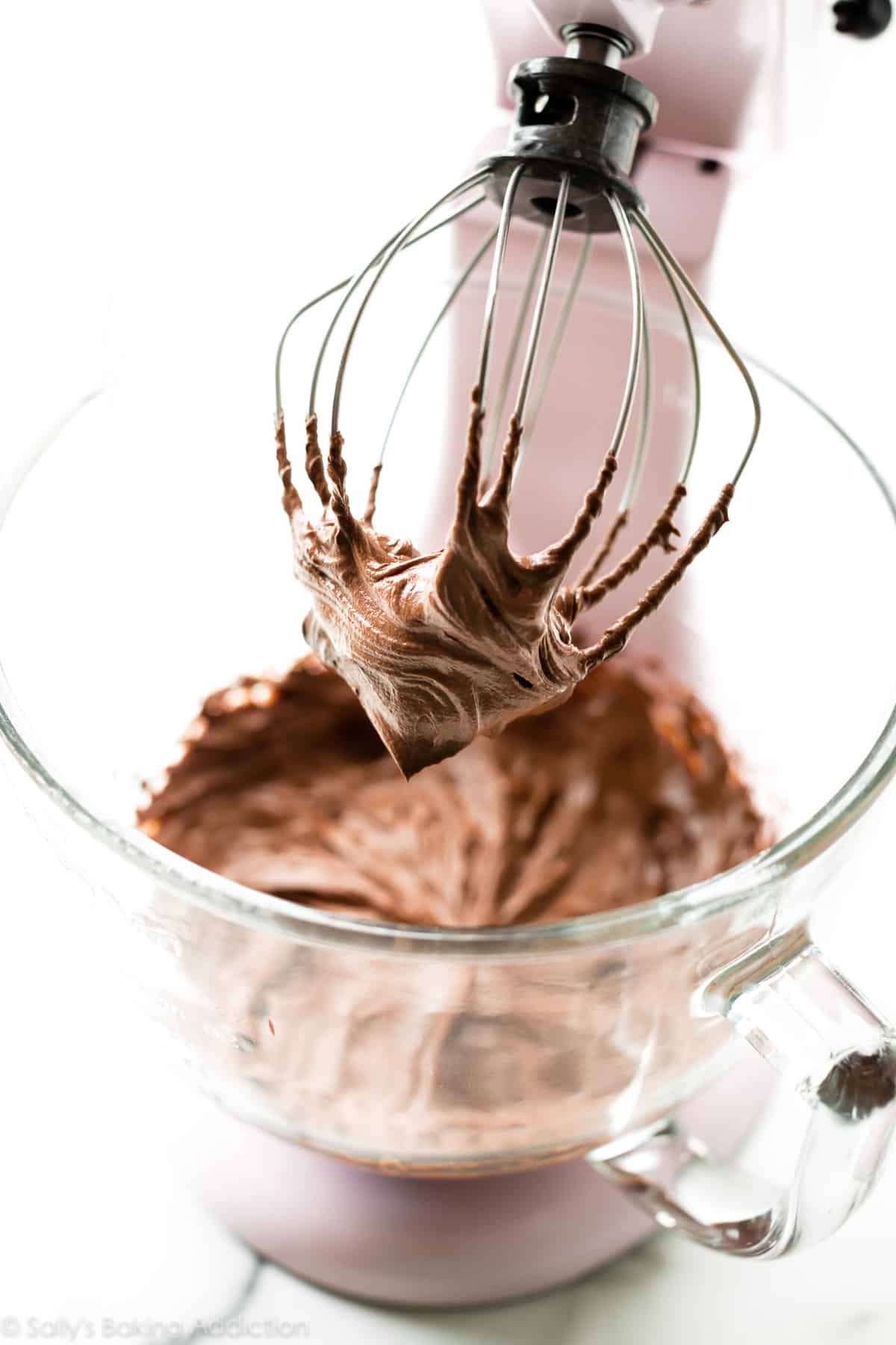 whipped chocolate ganache in a stand mixer bowl with whisk attachment