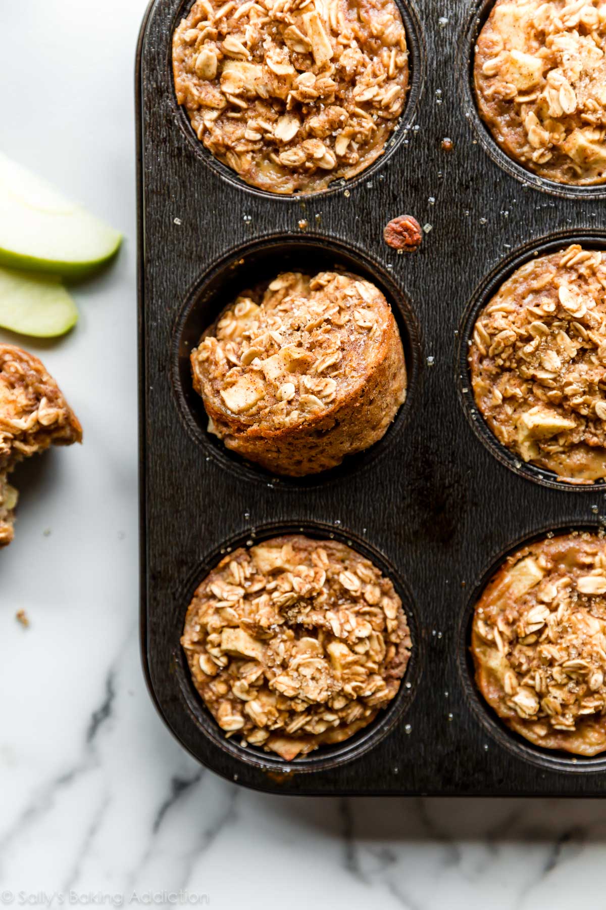 healthy apple cinnamon baked oatmeal cups in a muffin pan