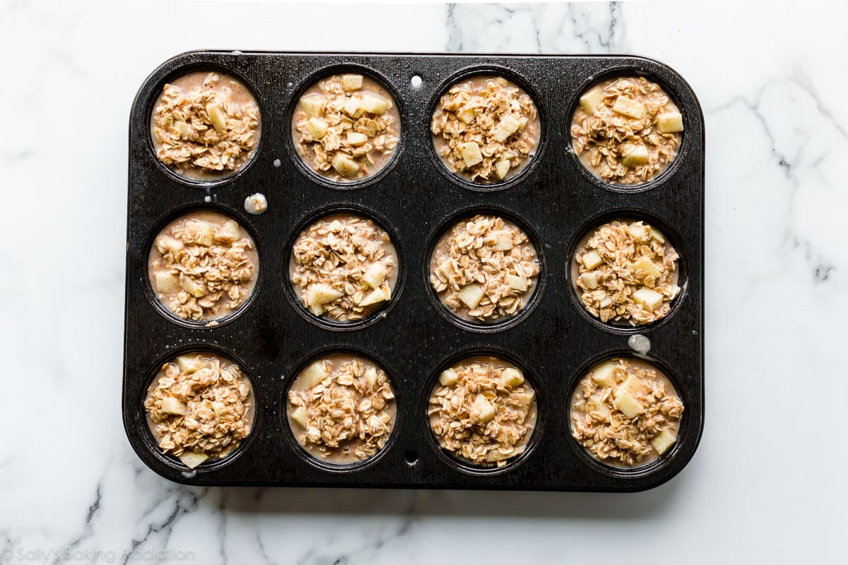 apple cinnamon oatmeal cups batter in a muffin pan