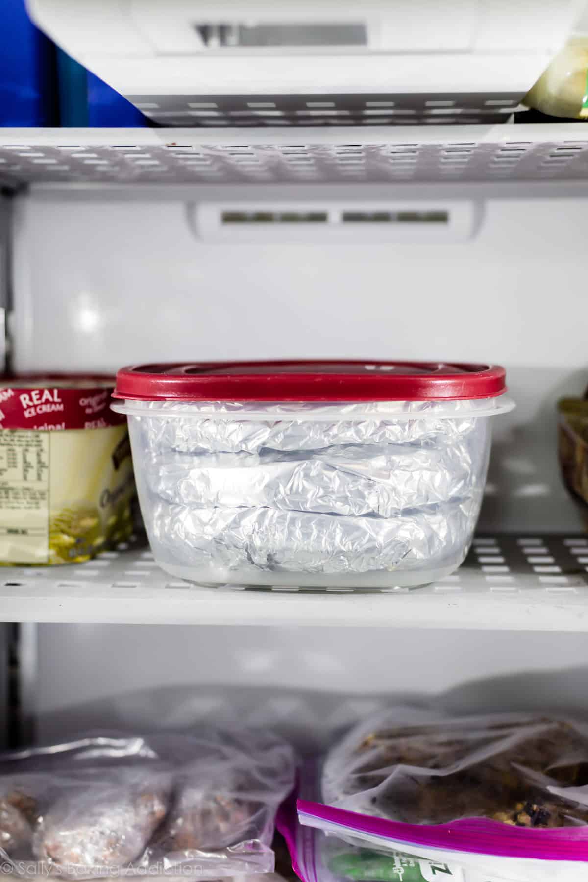 container of frozen cake layers in the freezer